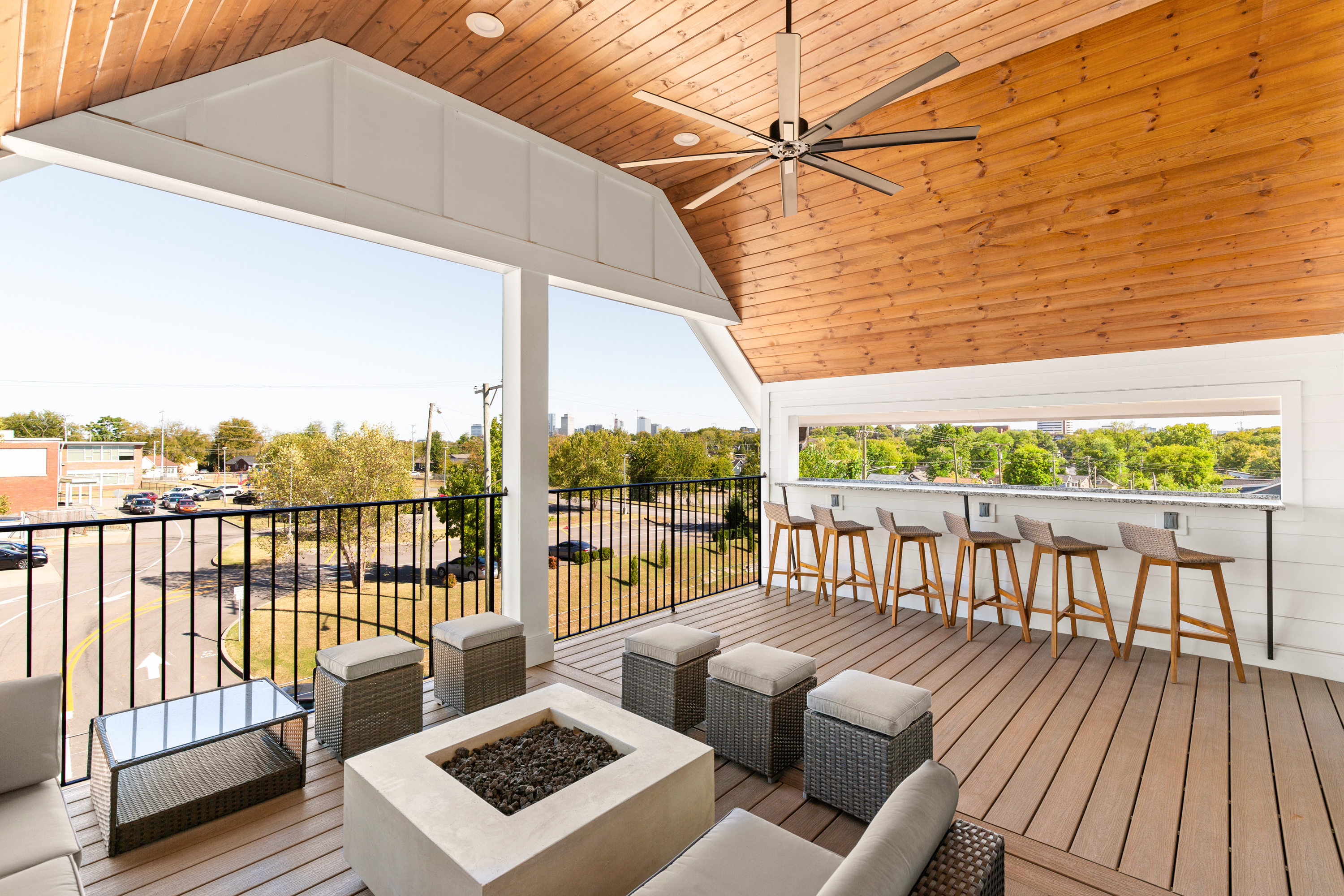 Outdoor lounge with wooden ceiling and modern bar setup